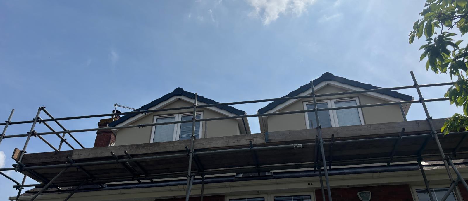 Scaffold up across a house with two dormers in Bristol