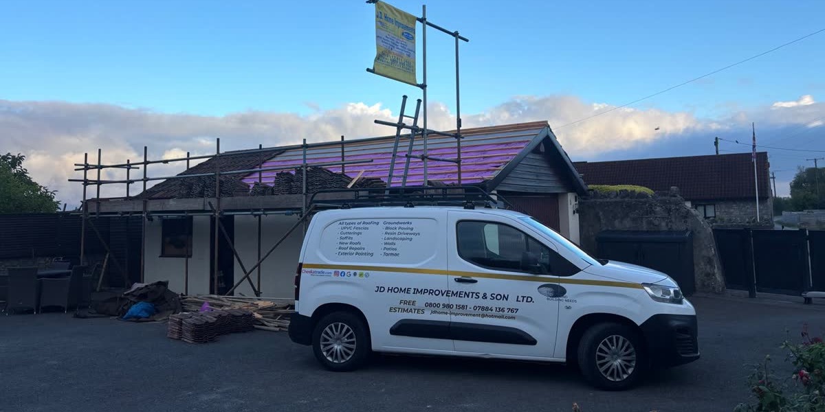Our van parked outside a bungalow being re-roofed, with scaffolding and new battens on the roof