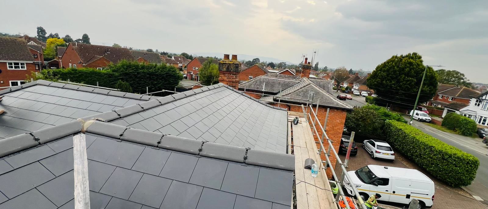 New slate roof seen from the scaffold above a street in Bristol