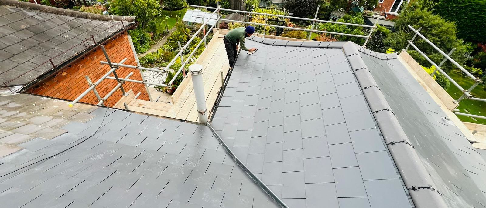 Grey slate roof finished on a large hipped house in Bristol