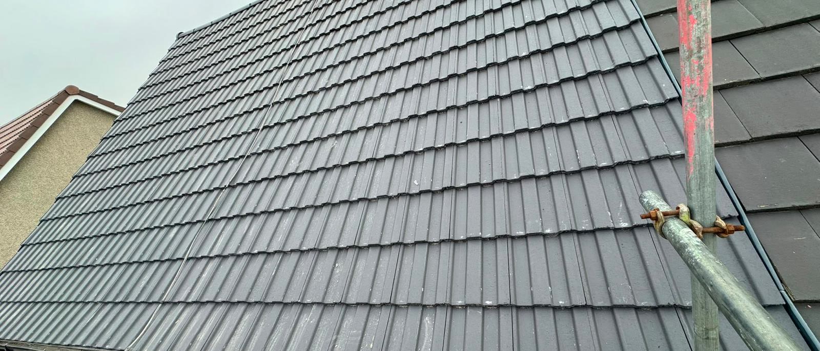 Finished grey tiled roof flashed in around the chimney, Bristol