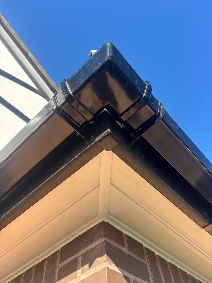 Black fascia and gutter corner with white soffit in Kingswood