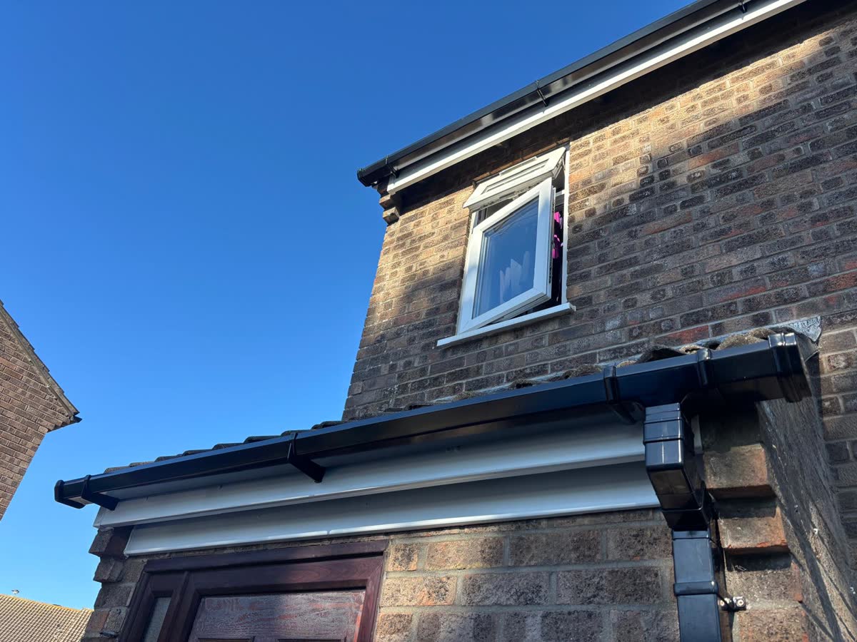 Black fascias and guttering on a brick extension in Portishead