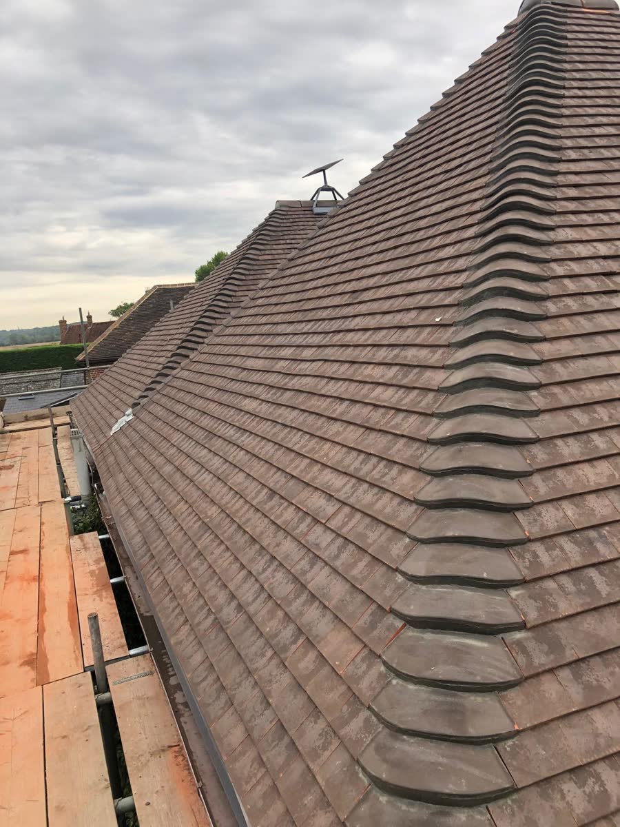 Clay plain tile hip roof after re-roofing in Henbury