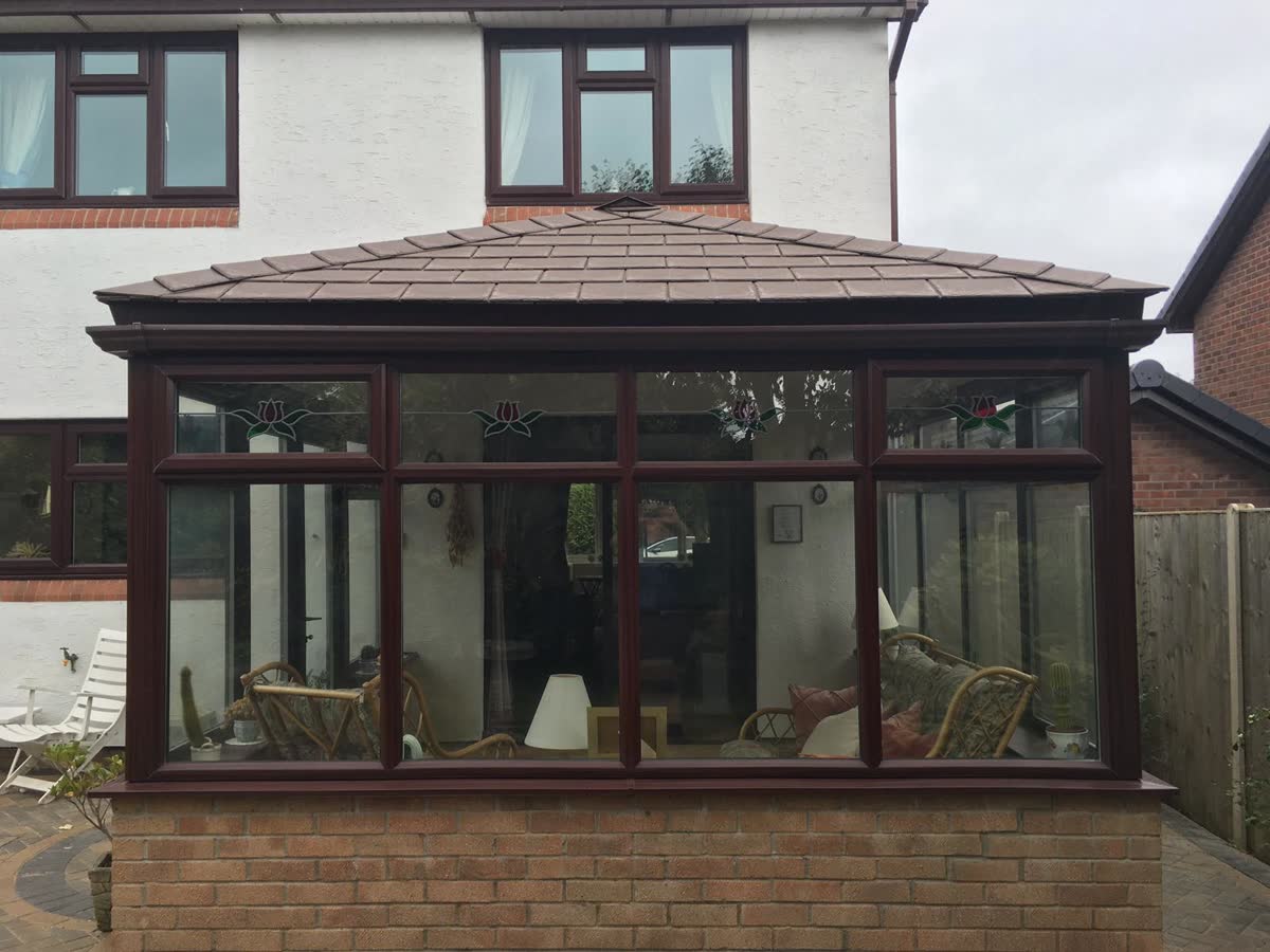 Front view of a conservatory with a tiled roof in Patchway