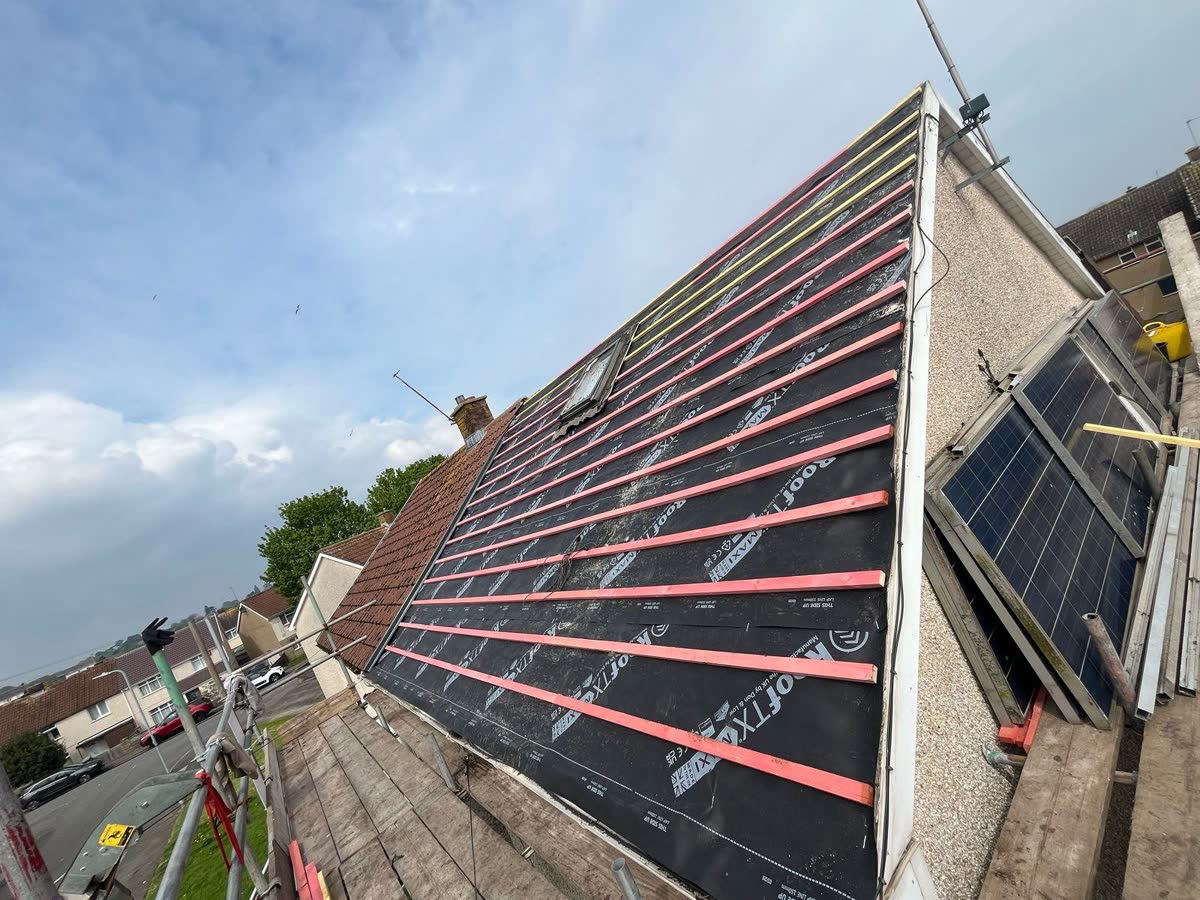 Re-roof under way with the solar panels lifted off in Cotham