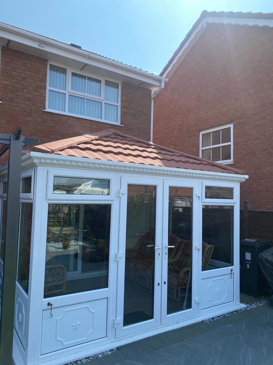 Red tiled conservatory roof against a brick house in Horfield