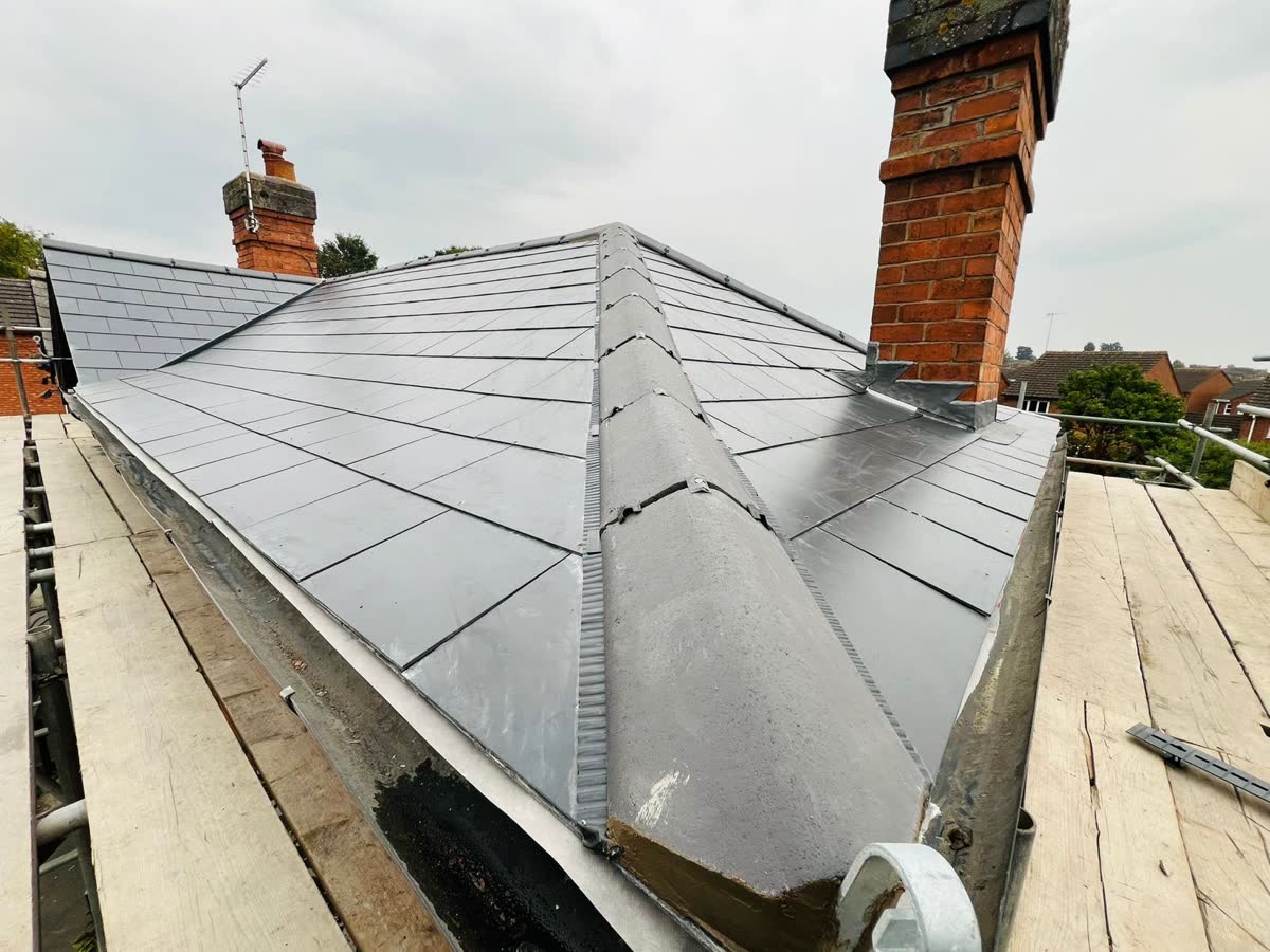 Slate roof meeting a brick chimney stack in Redland