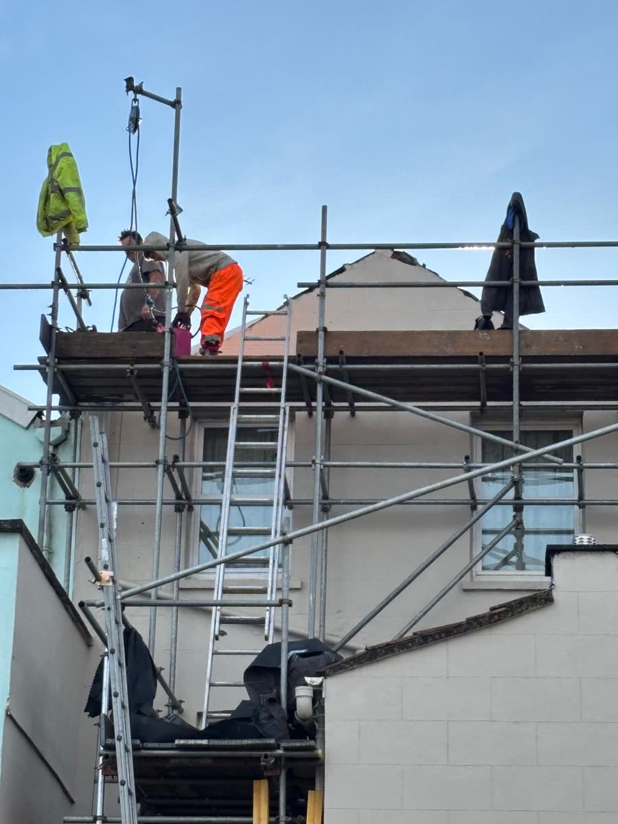 Two roofers at work on the scaffold in Portishead