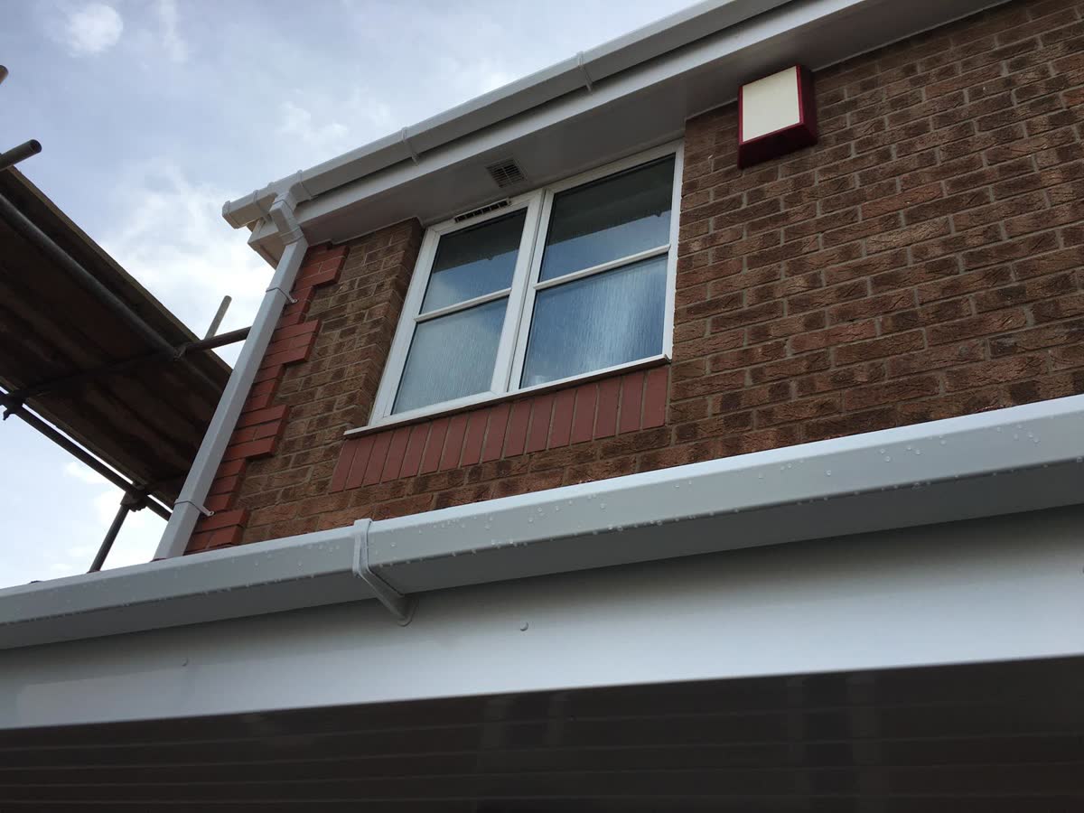 White fascia and gutter with scaffold alongside in Clifton