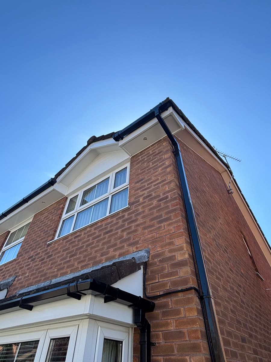 New black fascias and guttering on a brick house, Southmead