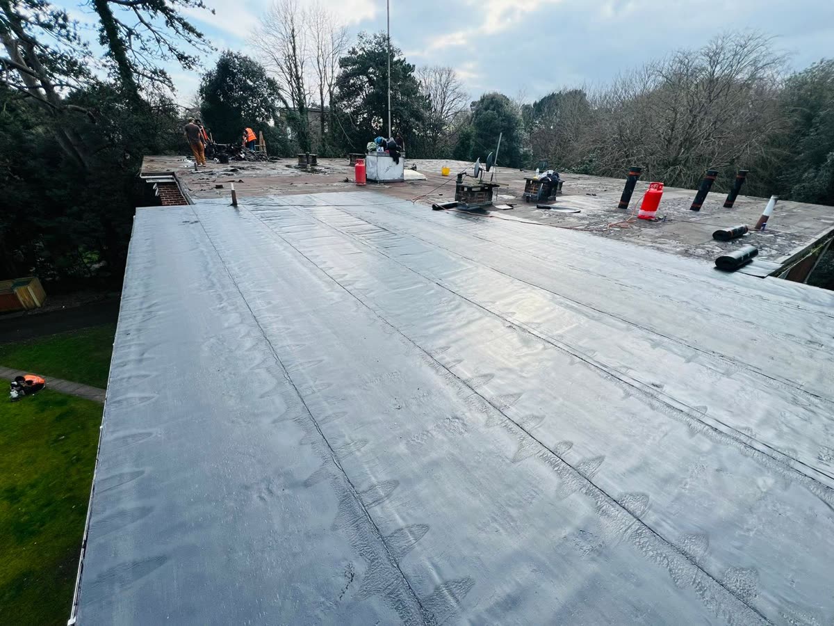 New felt laid in overlapping strips on a flat roof, Bedminster