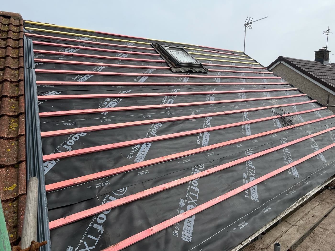 Roof stripped to new membrane and battens around a Velux window, Lawrence Weston